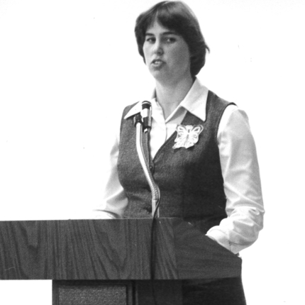 Woman speaking at lectern