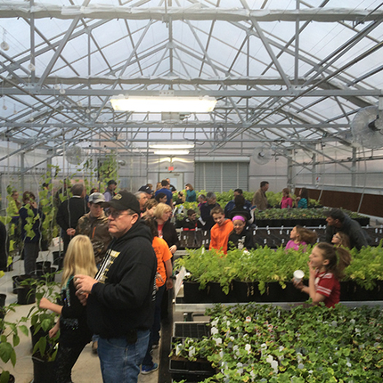 People touring school greenhouse
