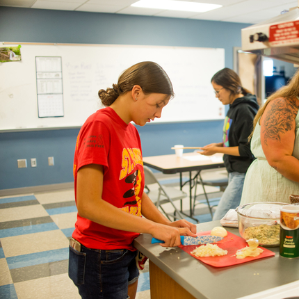 Student cutting onions
