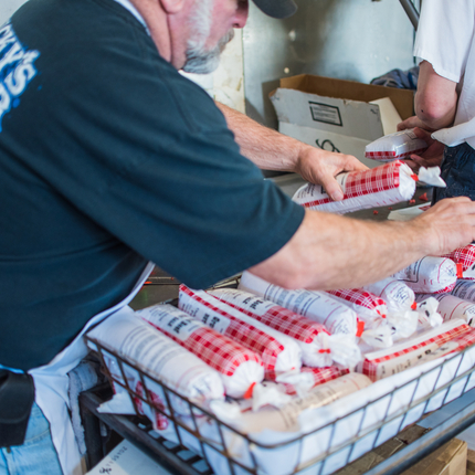 man handling processed meat