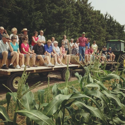 People on a hayrack on a farm tour