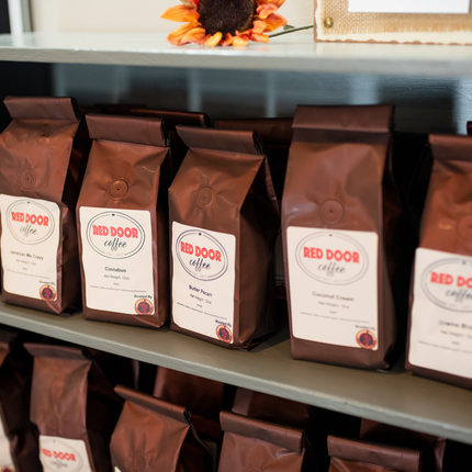 Retail shelf of bagged Red Door Coffee beans
