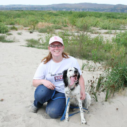 Woman with dog in sand