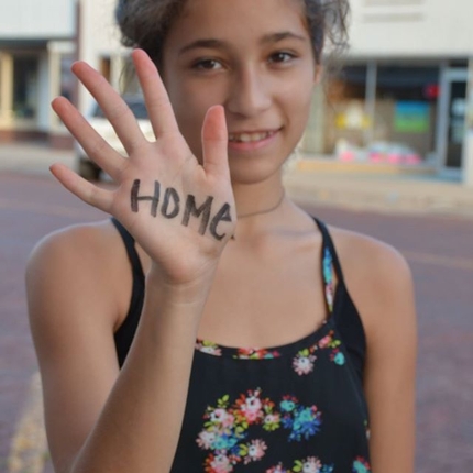 Girl with home written on her hand