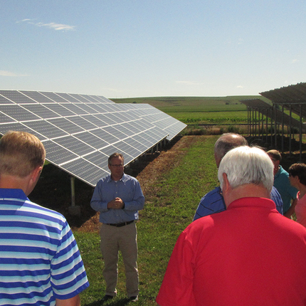 People on a tour to look at solar panels