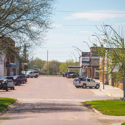 main street in a rural Community, with cars parked on both sides