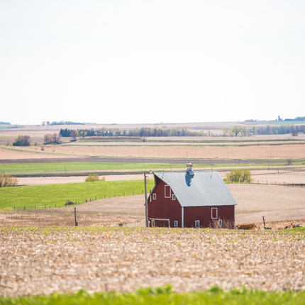 spring fields with barn in the center