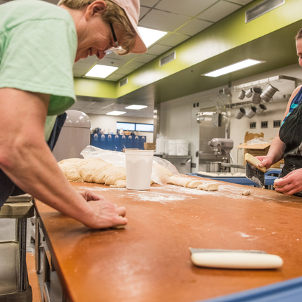 Cafeteria workers making bread