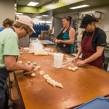 School cooks making bread