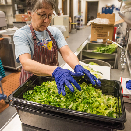 School cafeteria worker with local lettuce