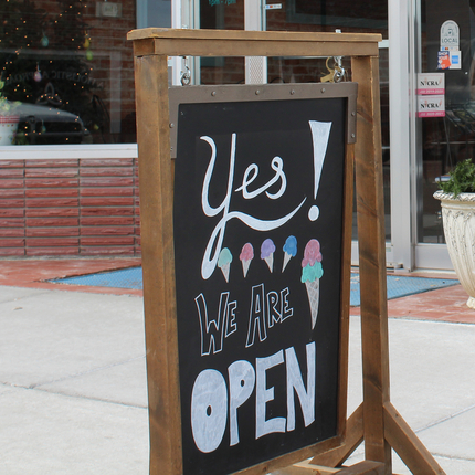 Yes we are open sign in front of ice cream shop