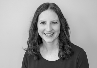 White female with medium-length hair. Black and white headshot.