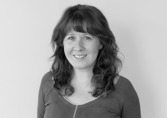 Heather Sparks headshot - woman with curly hair and bangs
