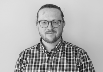 Nash Leef headshot - man with glasses and plaid shirt